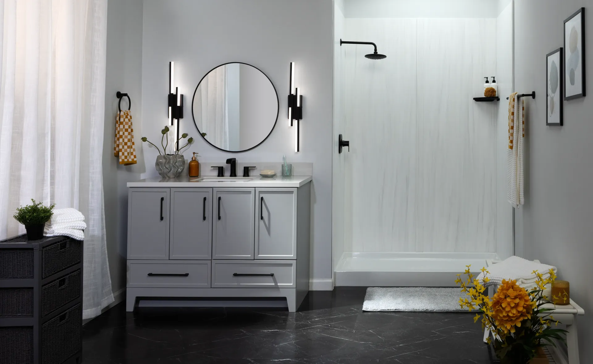 Modern bathroom with gray vanity, round mirror, white shower, and white-and-yellow floral accents