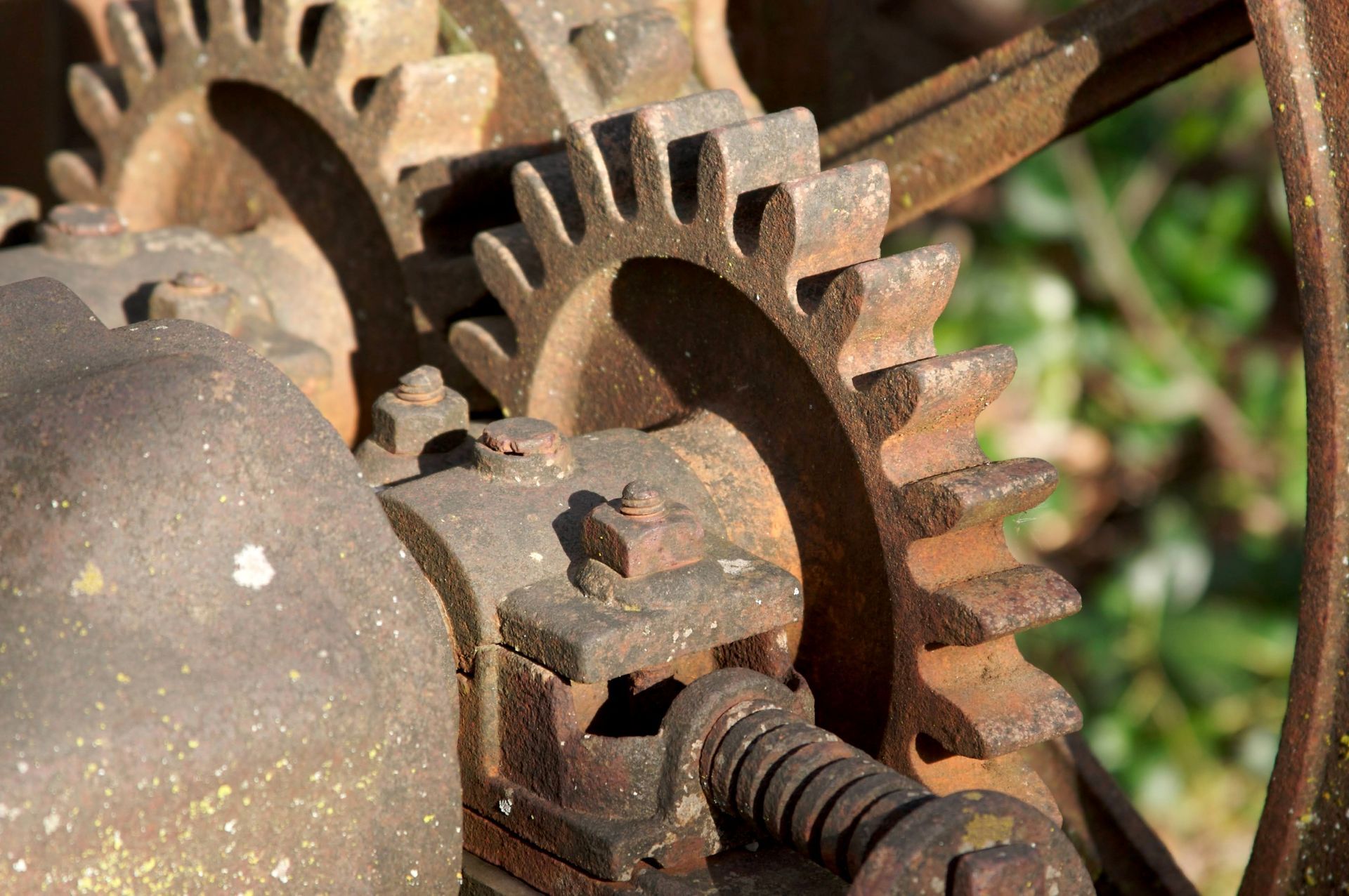 A close-up of a rusty gear on a machine.