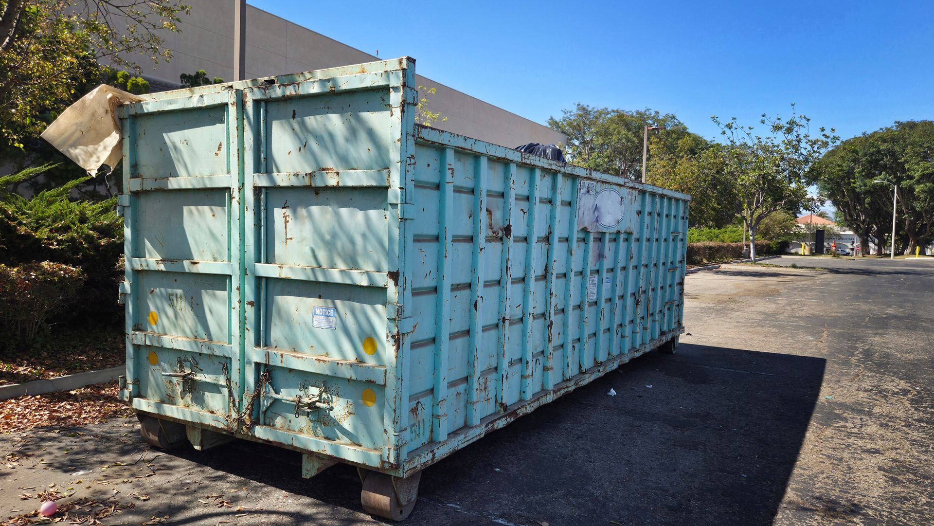 A large dumpster near a construction site.