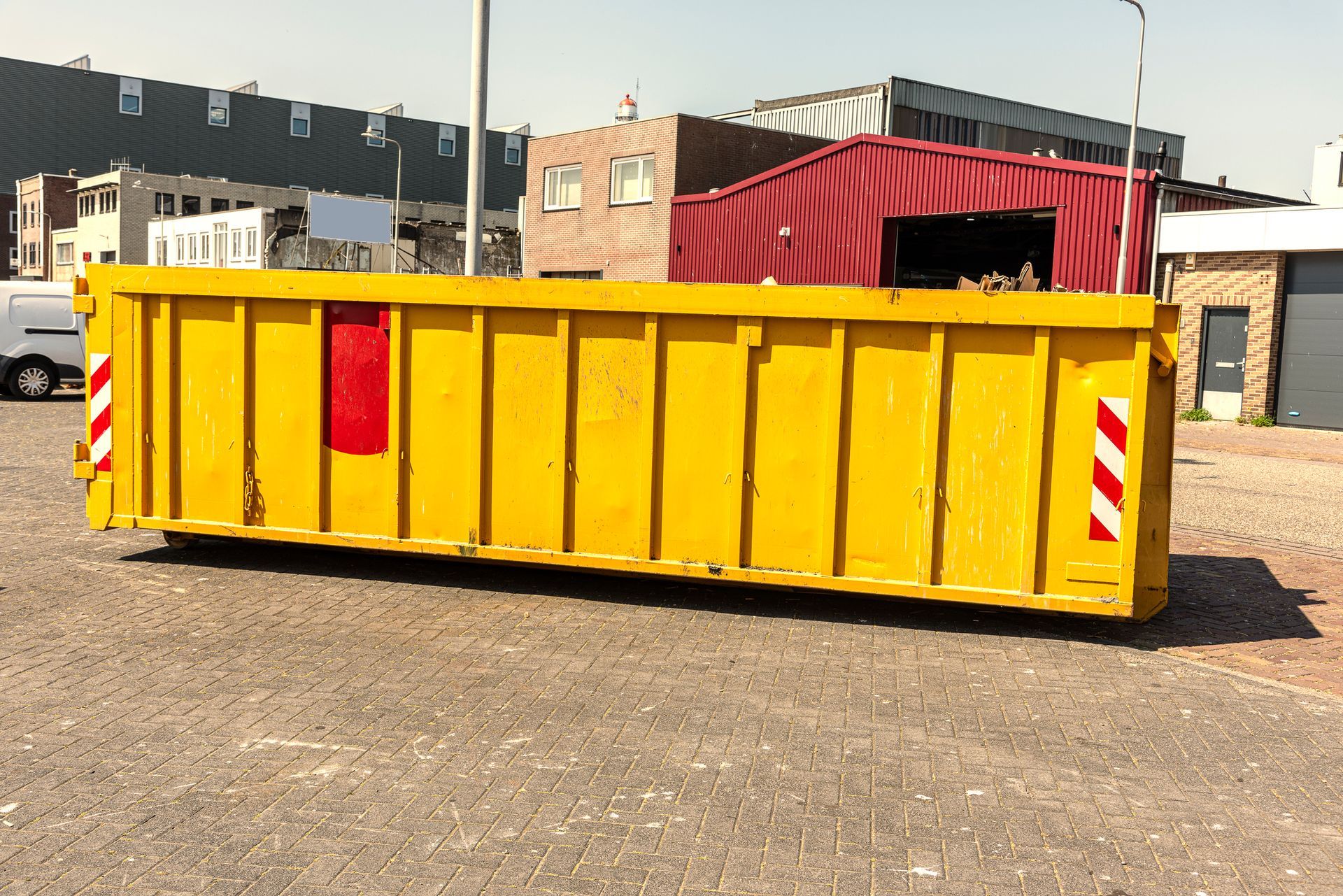 Long yellow open industrial waste container