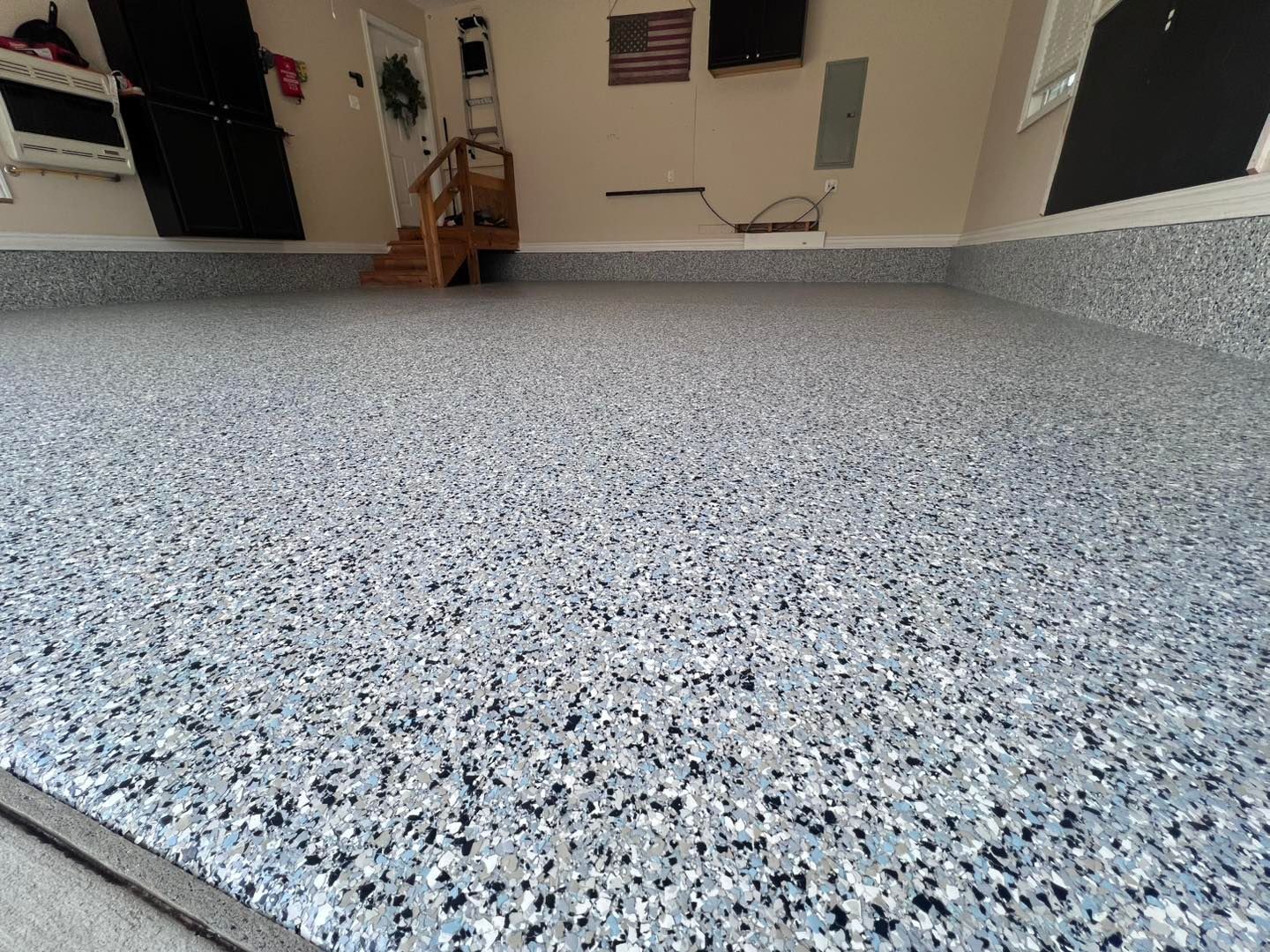 Garage floor with a speckled, blue-gray epoxy coating.