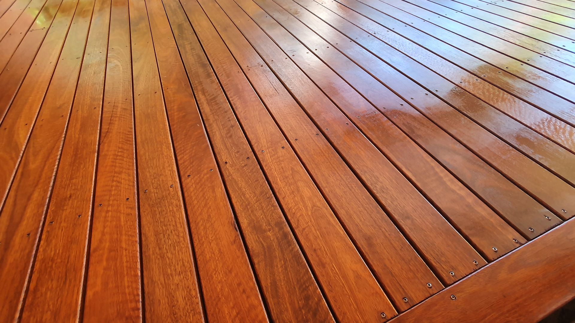 A close up of a wooden deck with a glossy finish