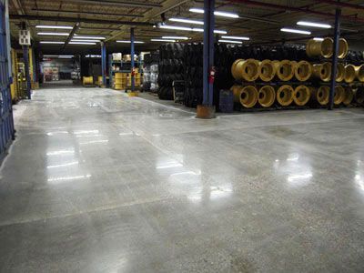 A large warehouse filled with lots of tires and barrels.