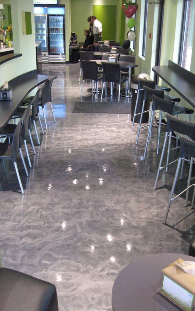 A restaurant with tables and chairs and a refrigerator.