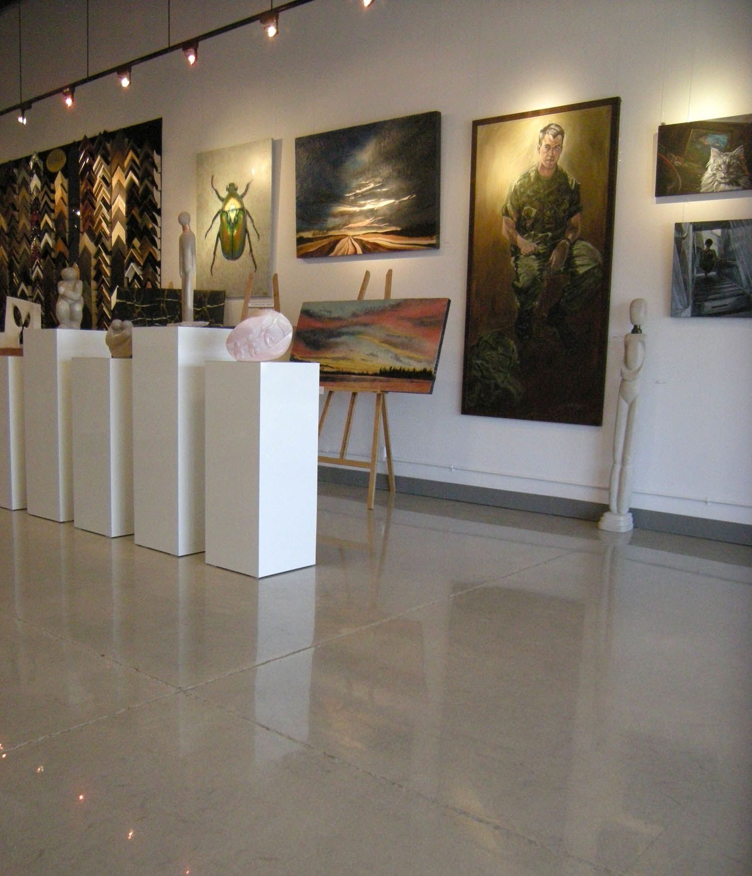 A room with a lot of paintings on the wall