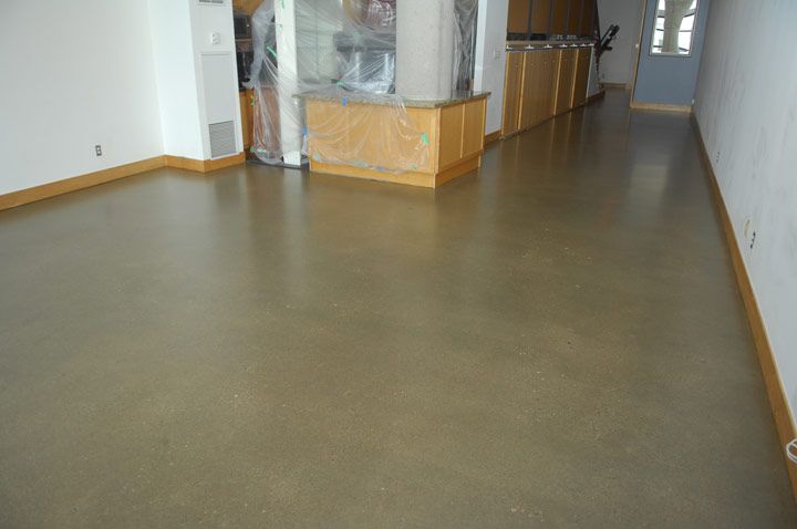 A long hallway with a concrete floor and a counter.