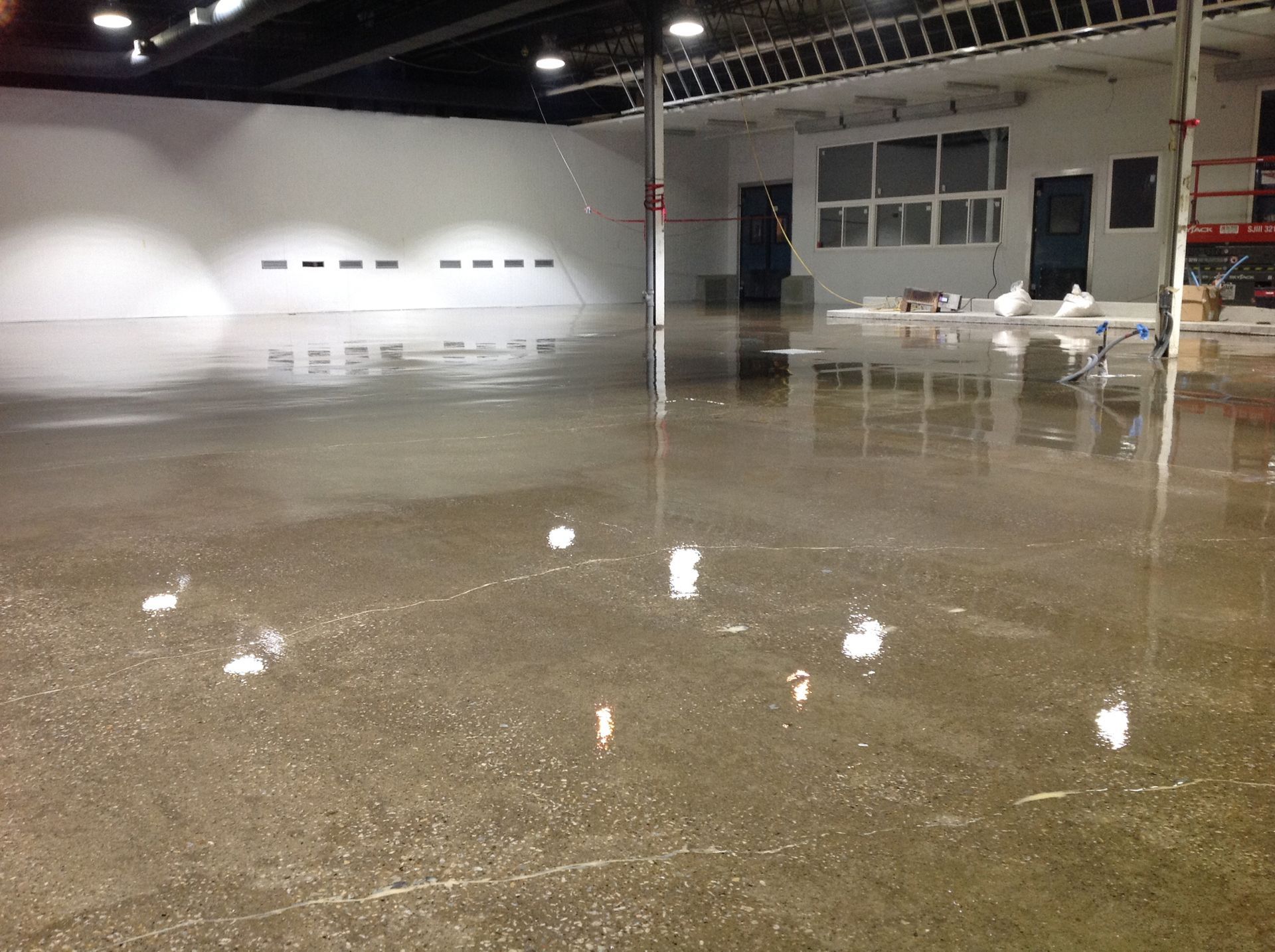 A large empty room with a shiny concrete floor