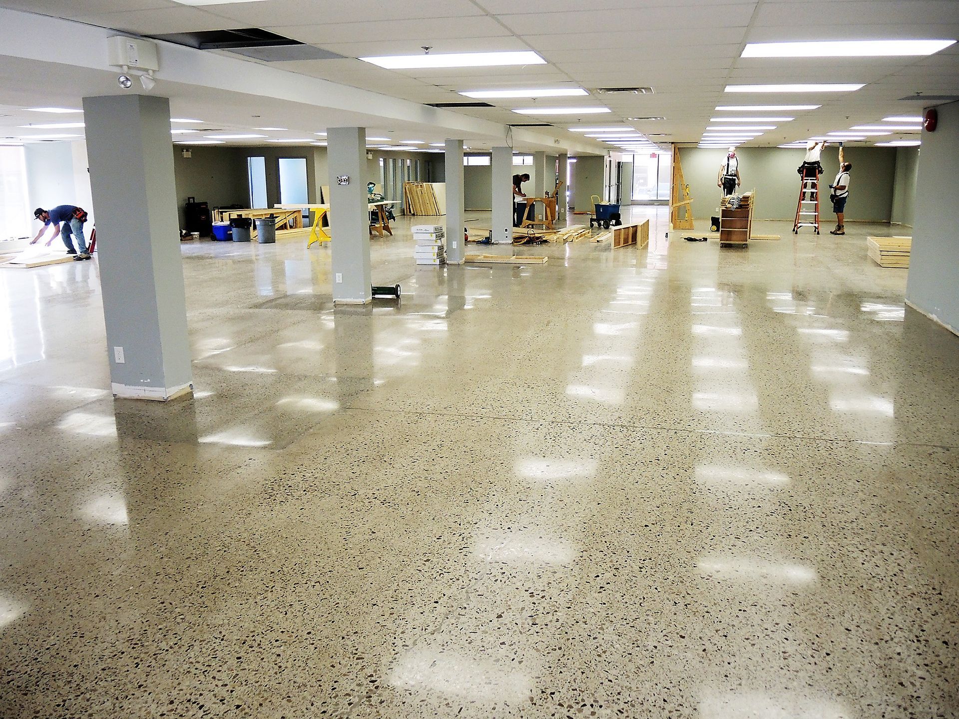 A large empty room with a shiny concrete floor