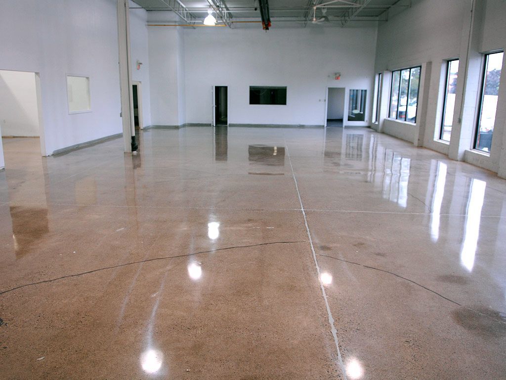 A large empty room with a shiny concrete floor