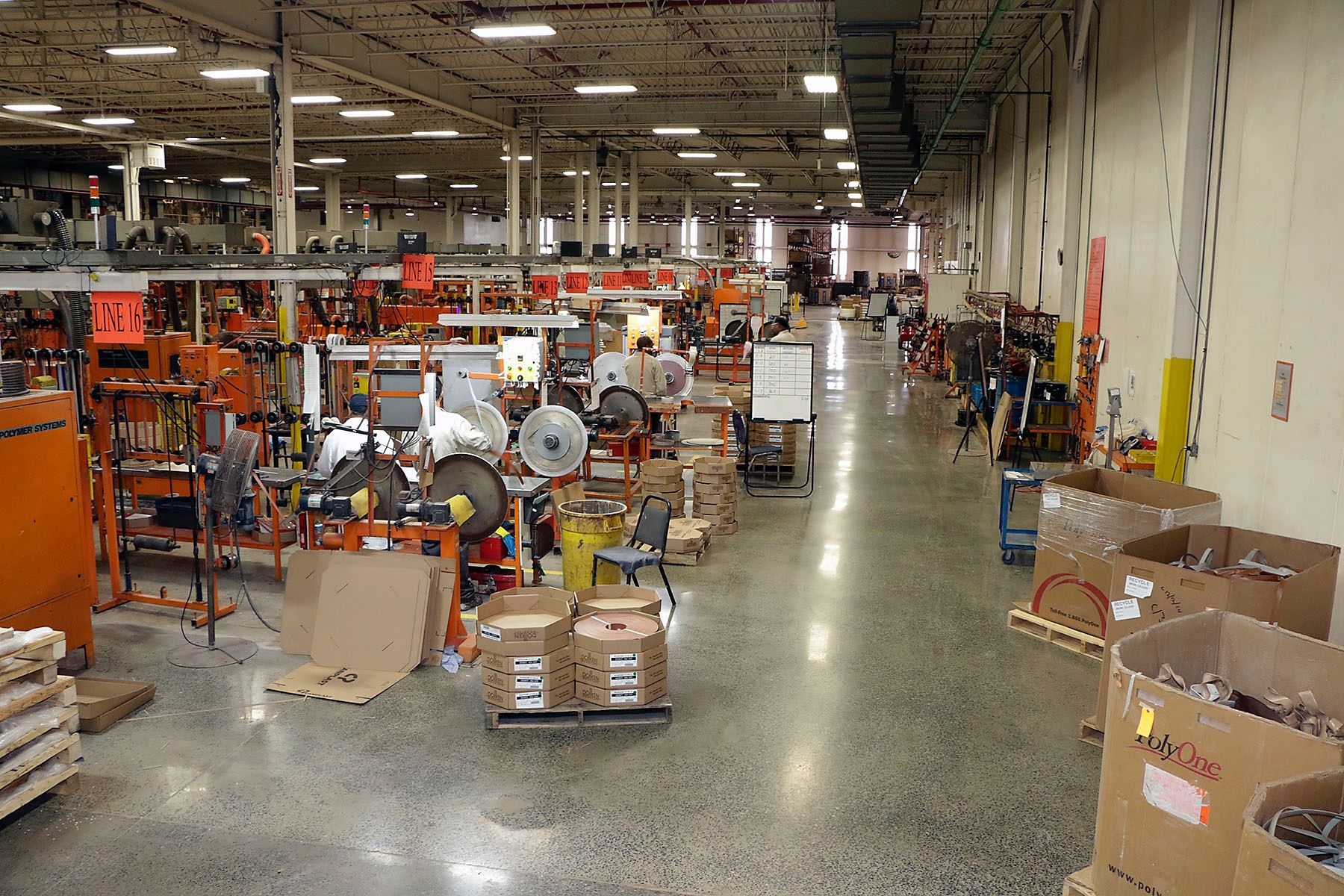 A large warehouse filled with lots of boxes and machinery