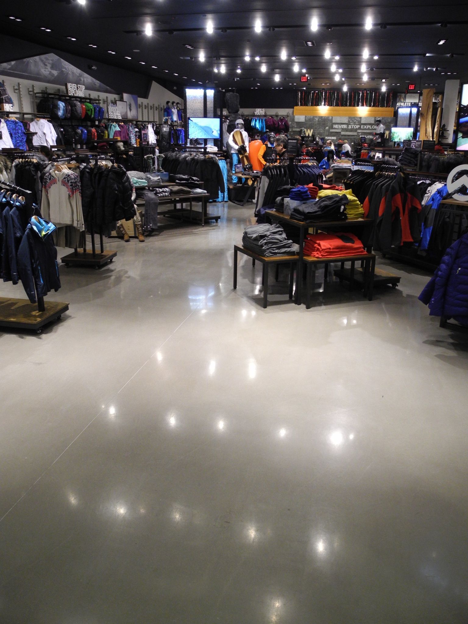 A large clothing store with a lot of clothes on display