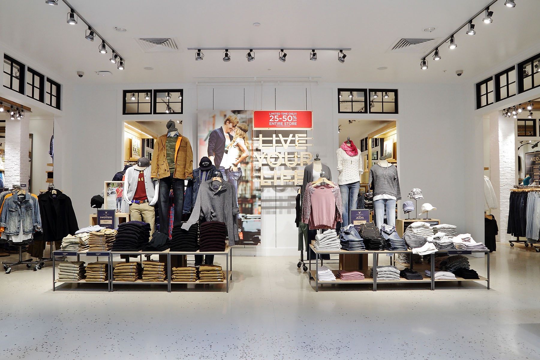 A clothing store with a lot of clothes on display.