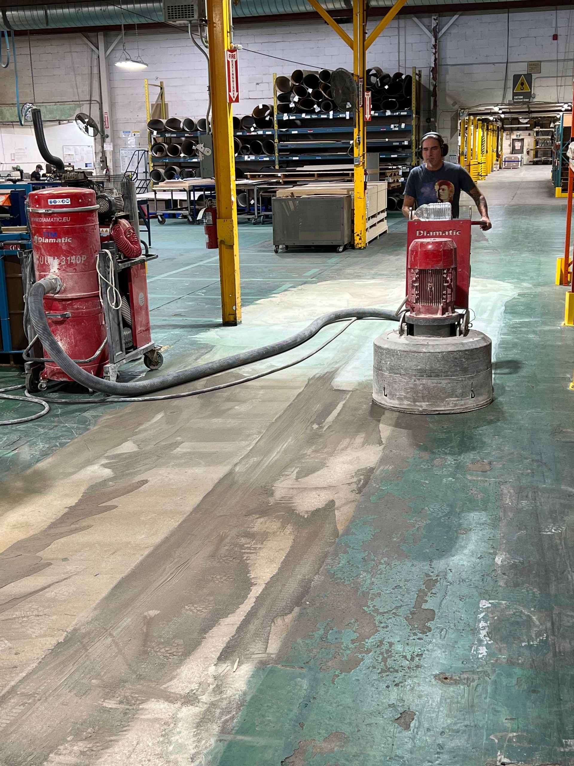 A man is working on a machine in a warehouse
