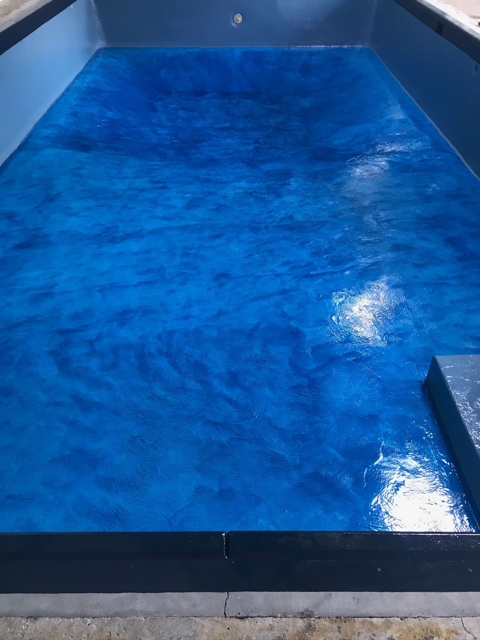 A large swimming pool filled with blue water.
