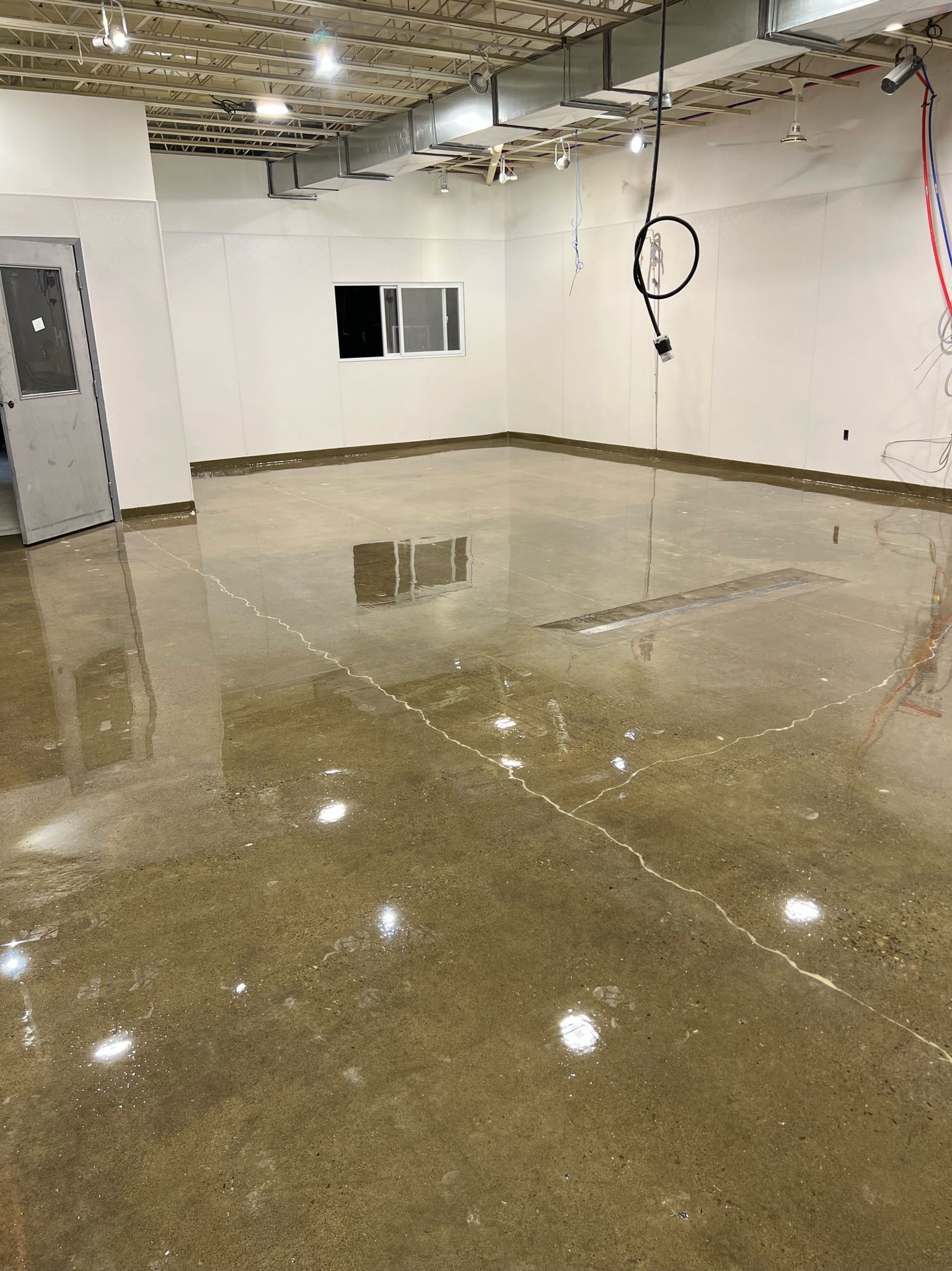 A large room with a concrete floor and white walls