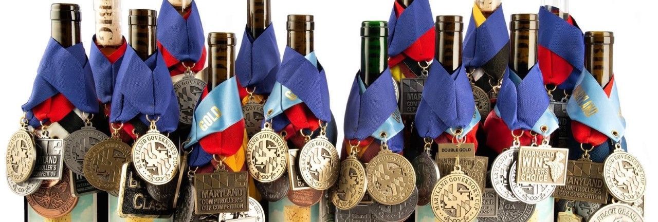 A group of wine bottles with medals on them