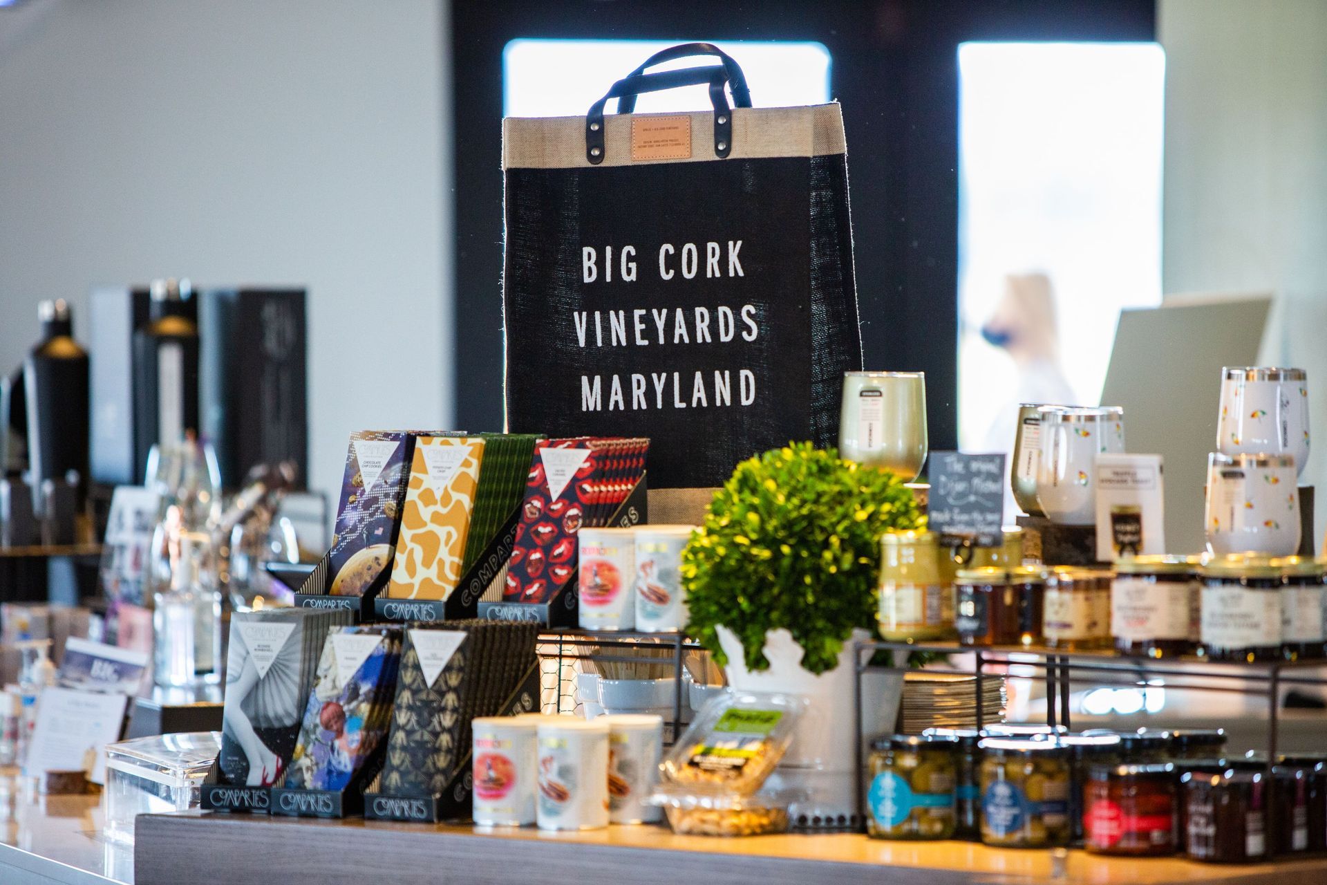 A table with a sign that says big cork vineyards maryland on it.