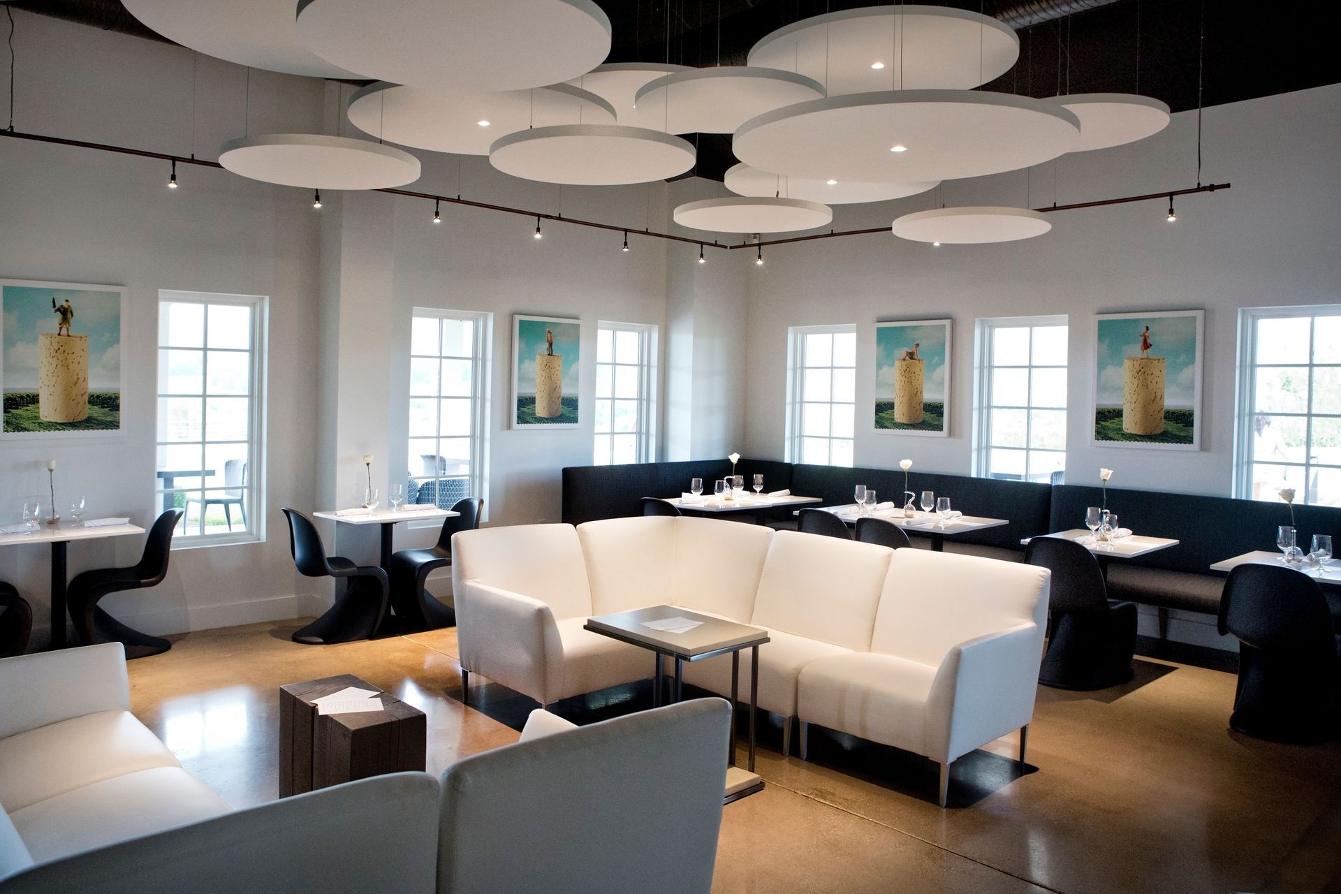 A restaurant with tables and chairs and a couch