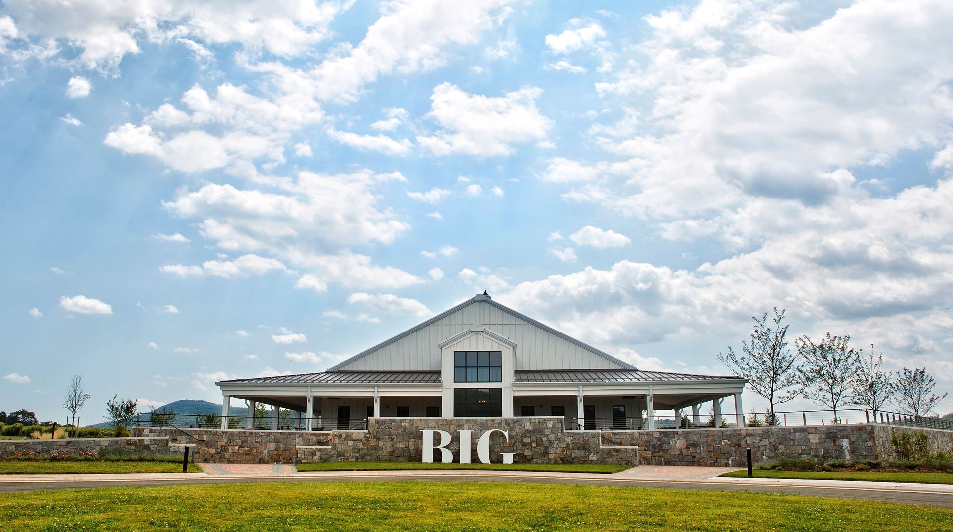 A large white building with a sign that says big on it