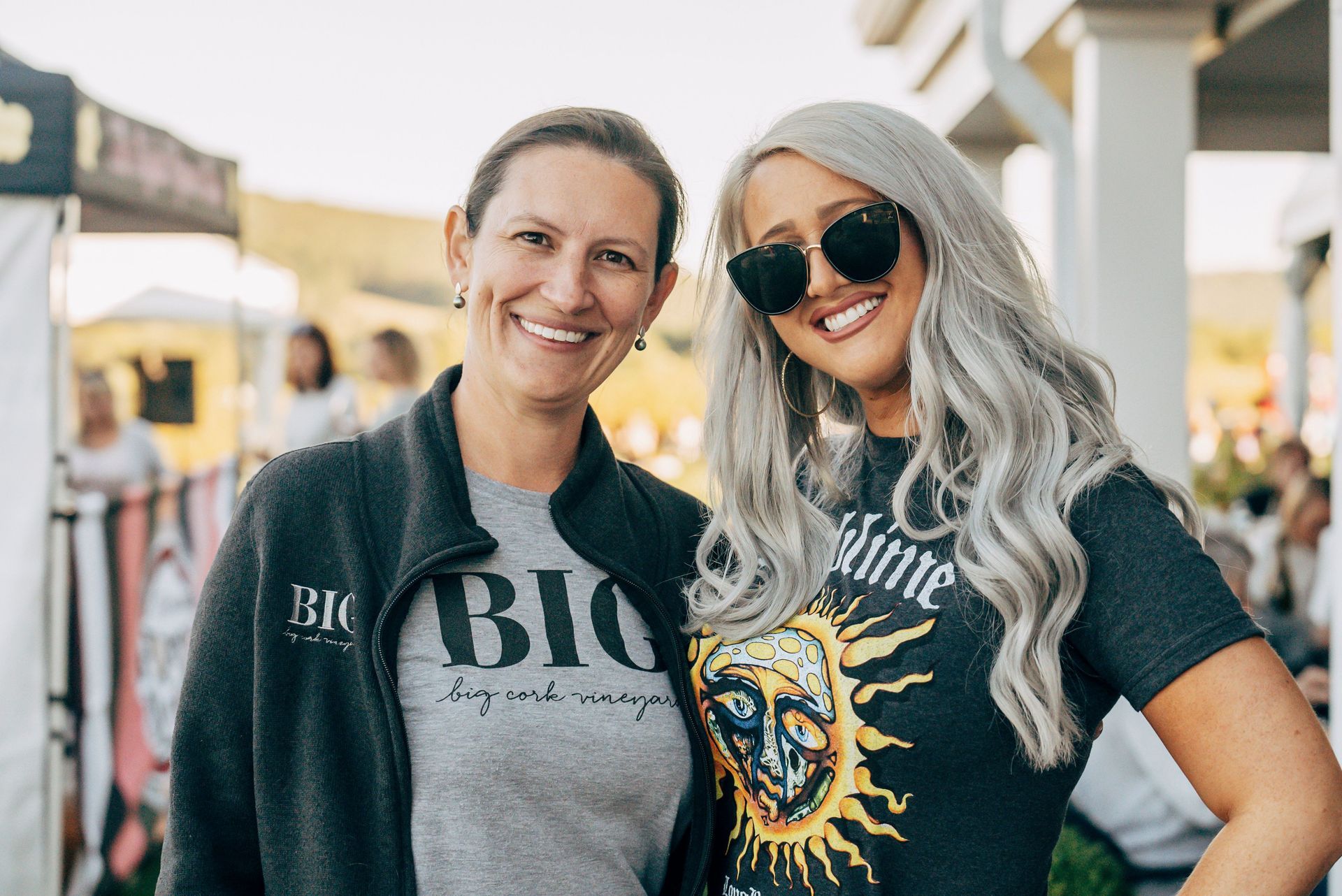 Two women are posing for a picture together and smiling.