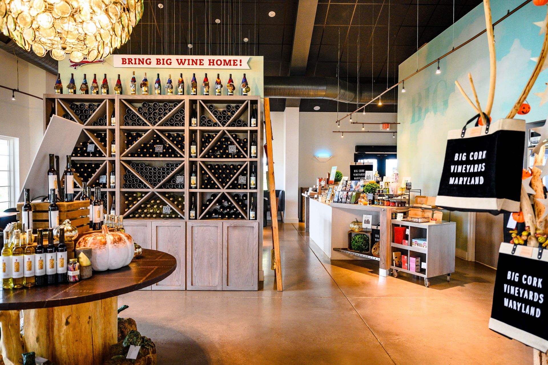 A store filled with lots of wine bottles and a table.