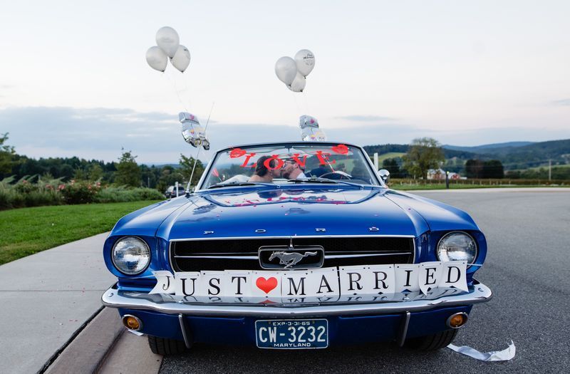 A blue mustang with a just married sign on the front