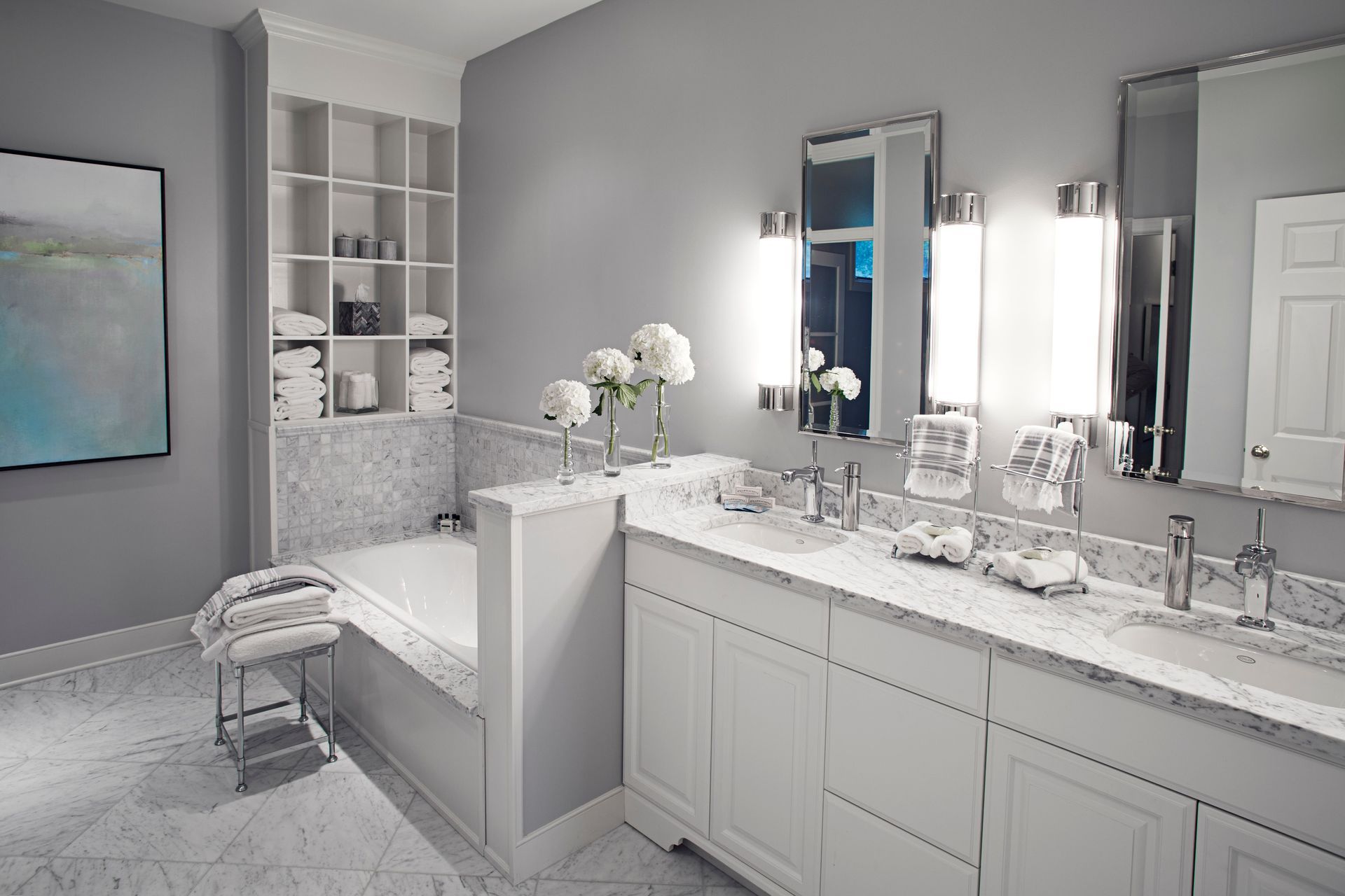 A bathroom with two sinks , two mirrors and a bathtub.