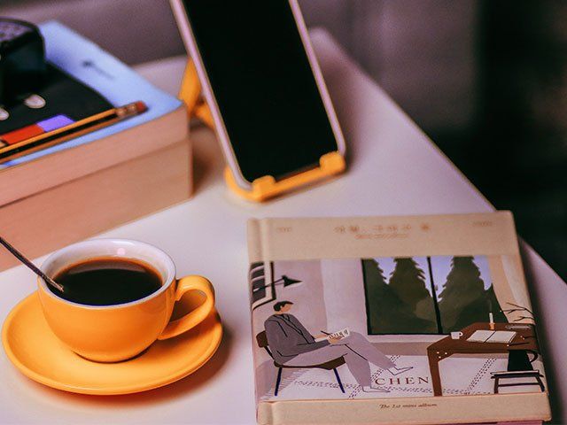Coffee, book and phone on a table