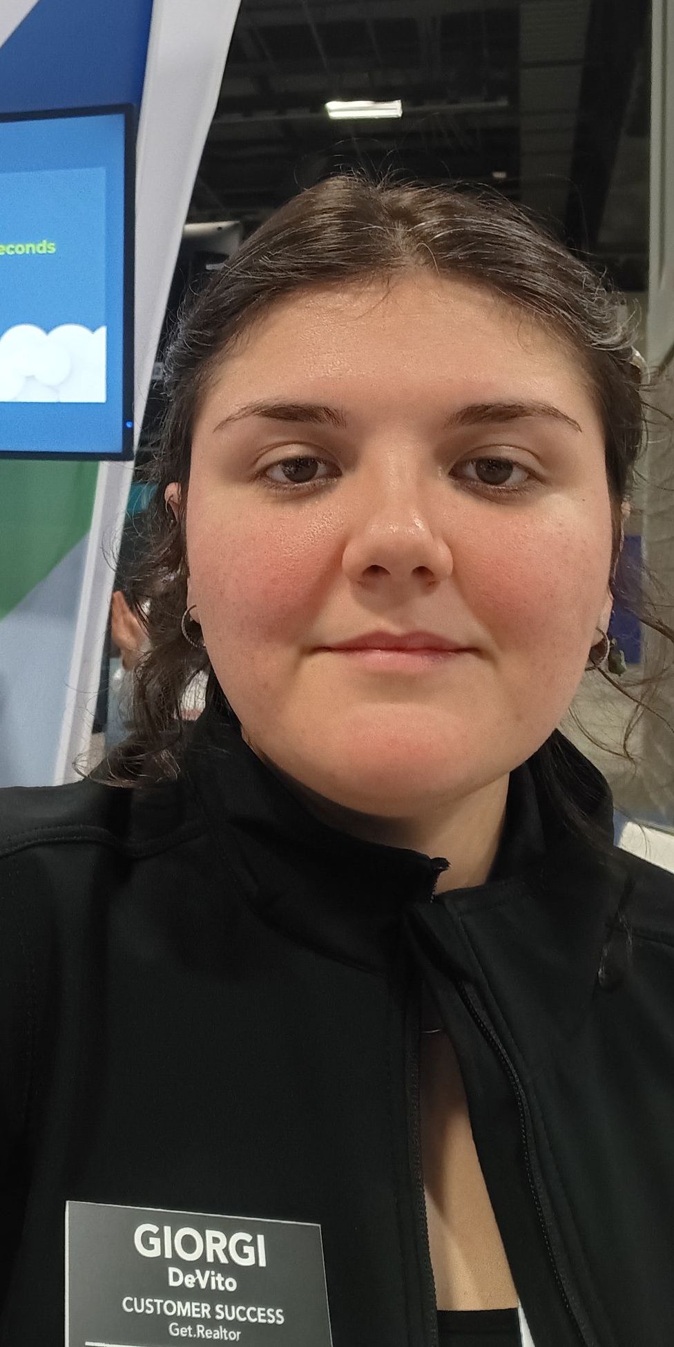 A woman is wearing a name tag that says giorgi on it.