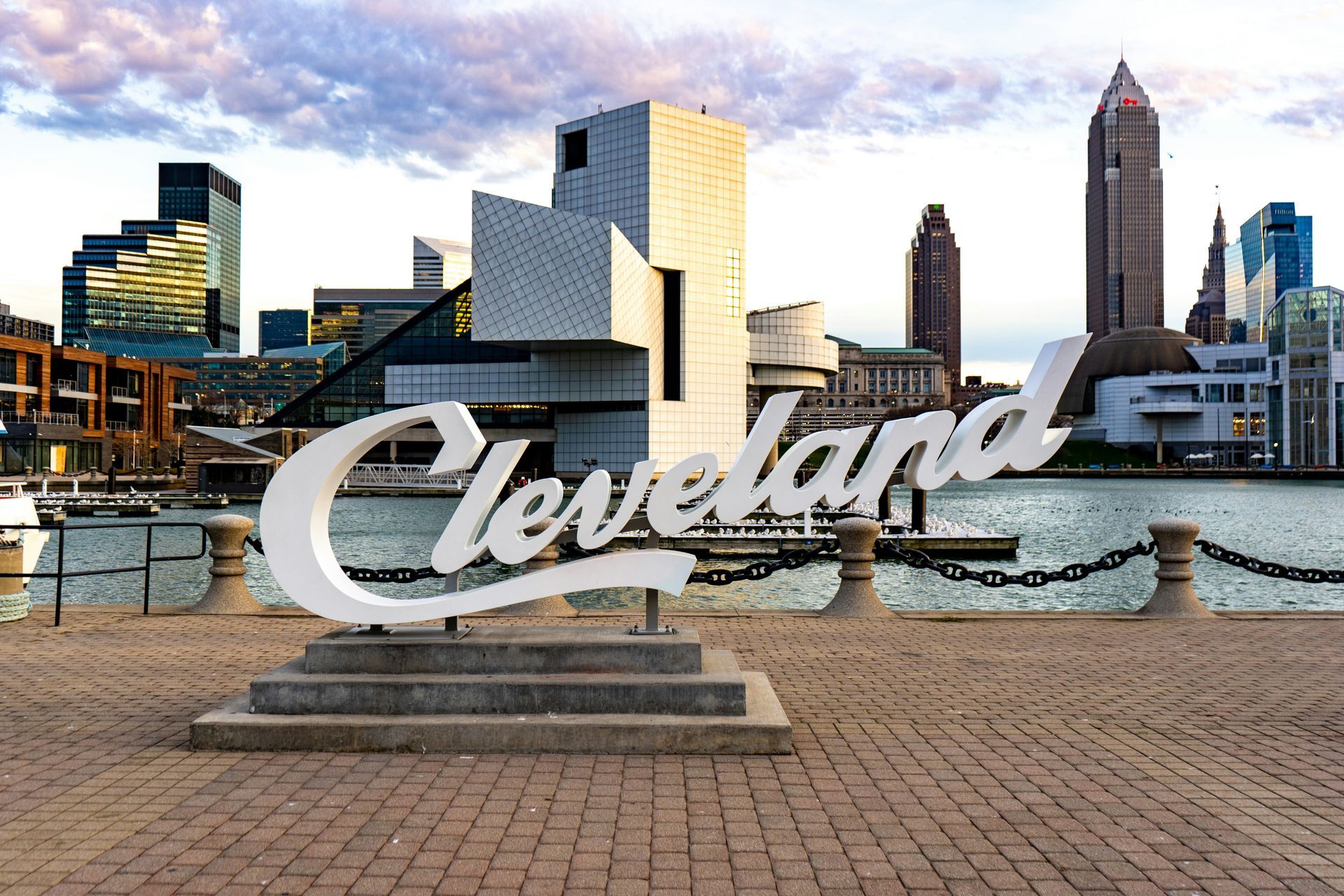 A sign that says cleveland in front of a city skyline