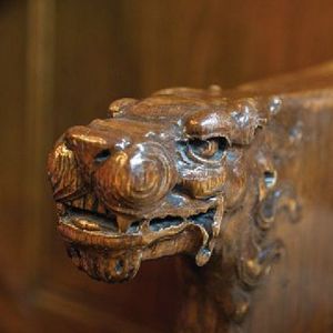 A close up of a wooden carving of a dragon 's head.