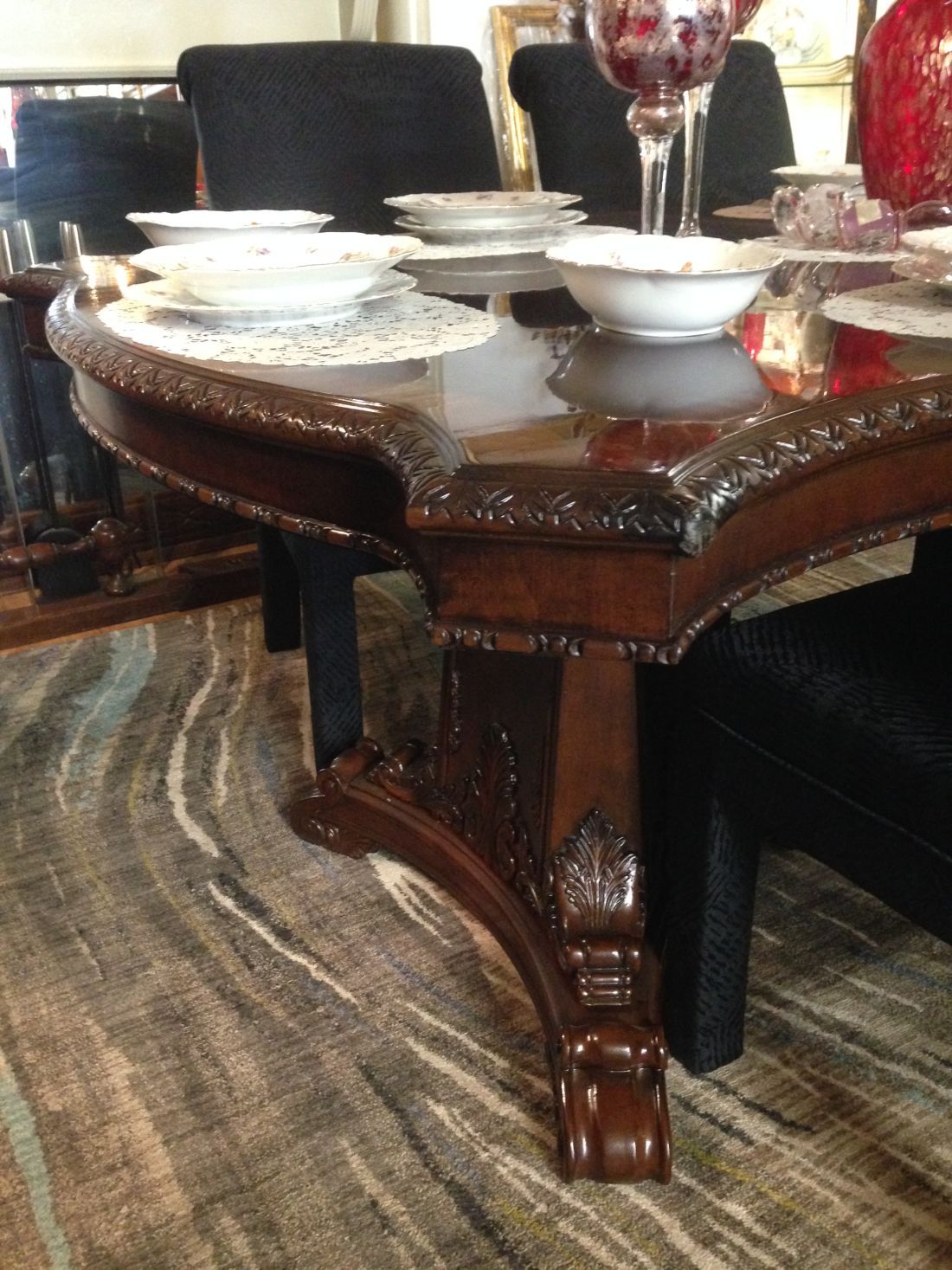A dining room table with plates and bowls on it