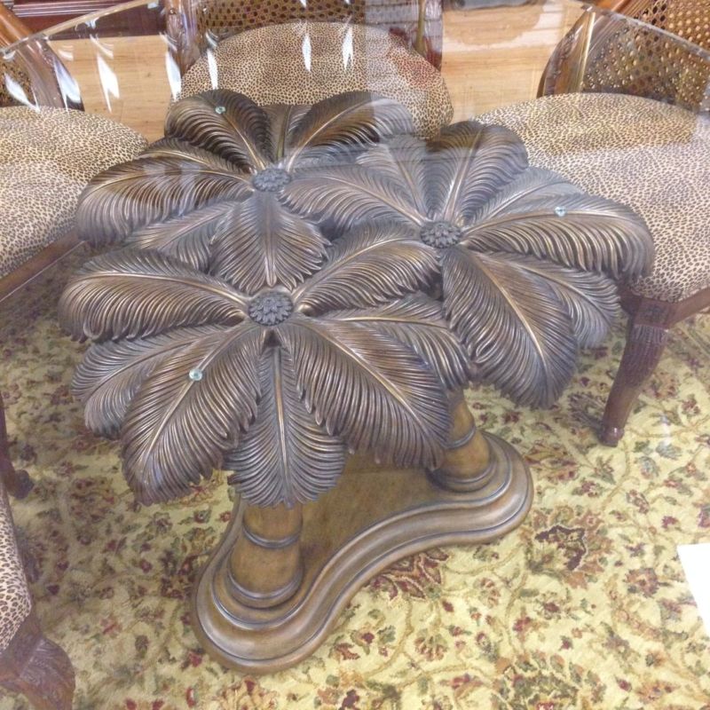 A table with feathers on it and a glass top