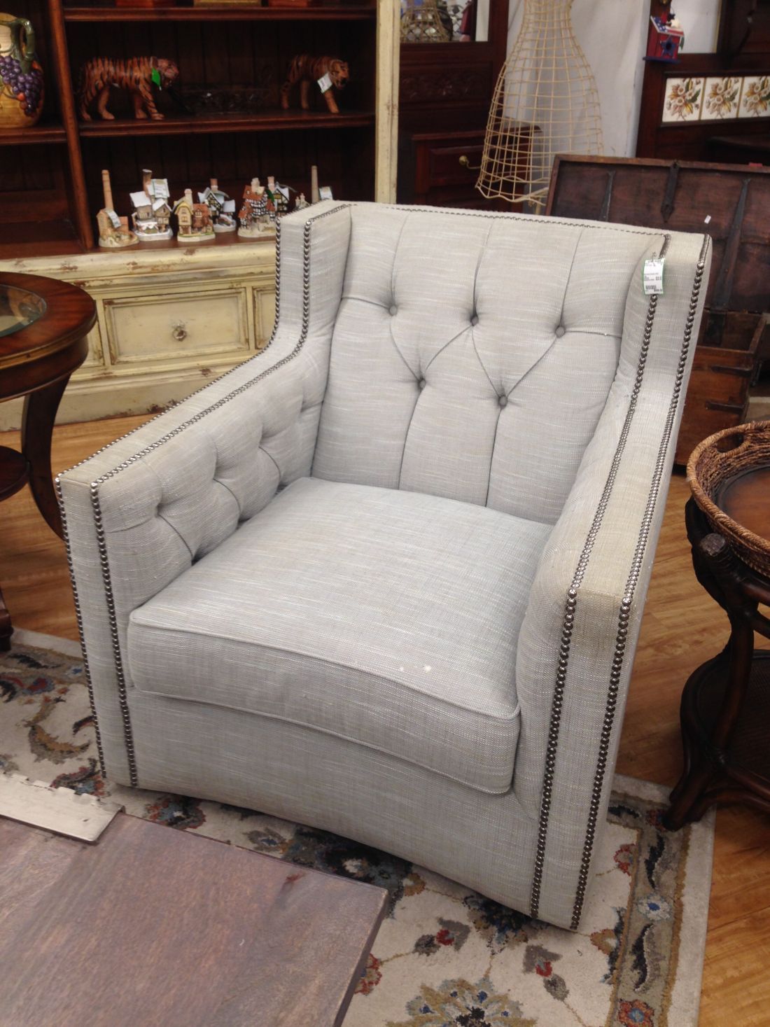 A grey chair is sitting on a rug in a room