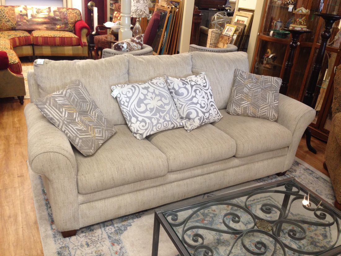 A couch is sitting next to a coffee table in a living room.