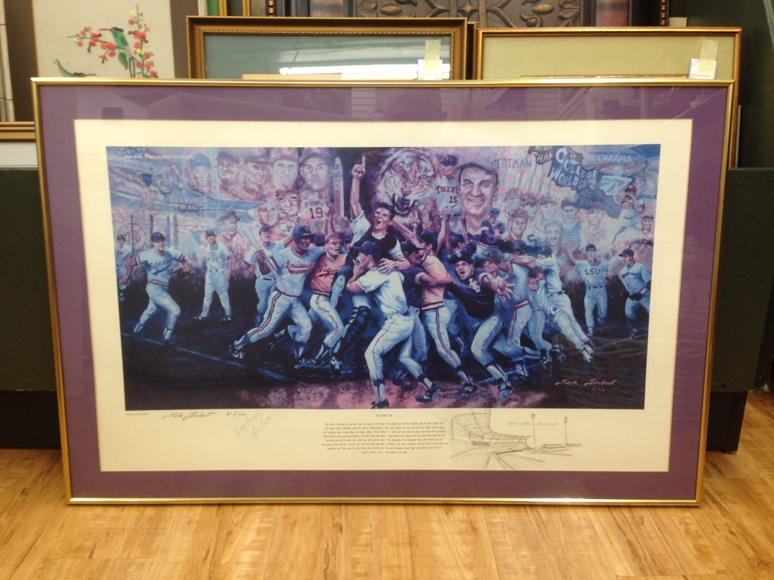 A framed picture of a baseball team is on a wooden floor.