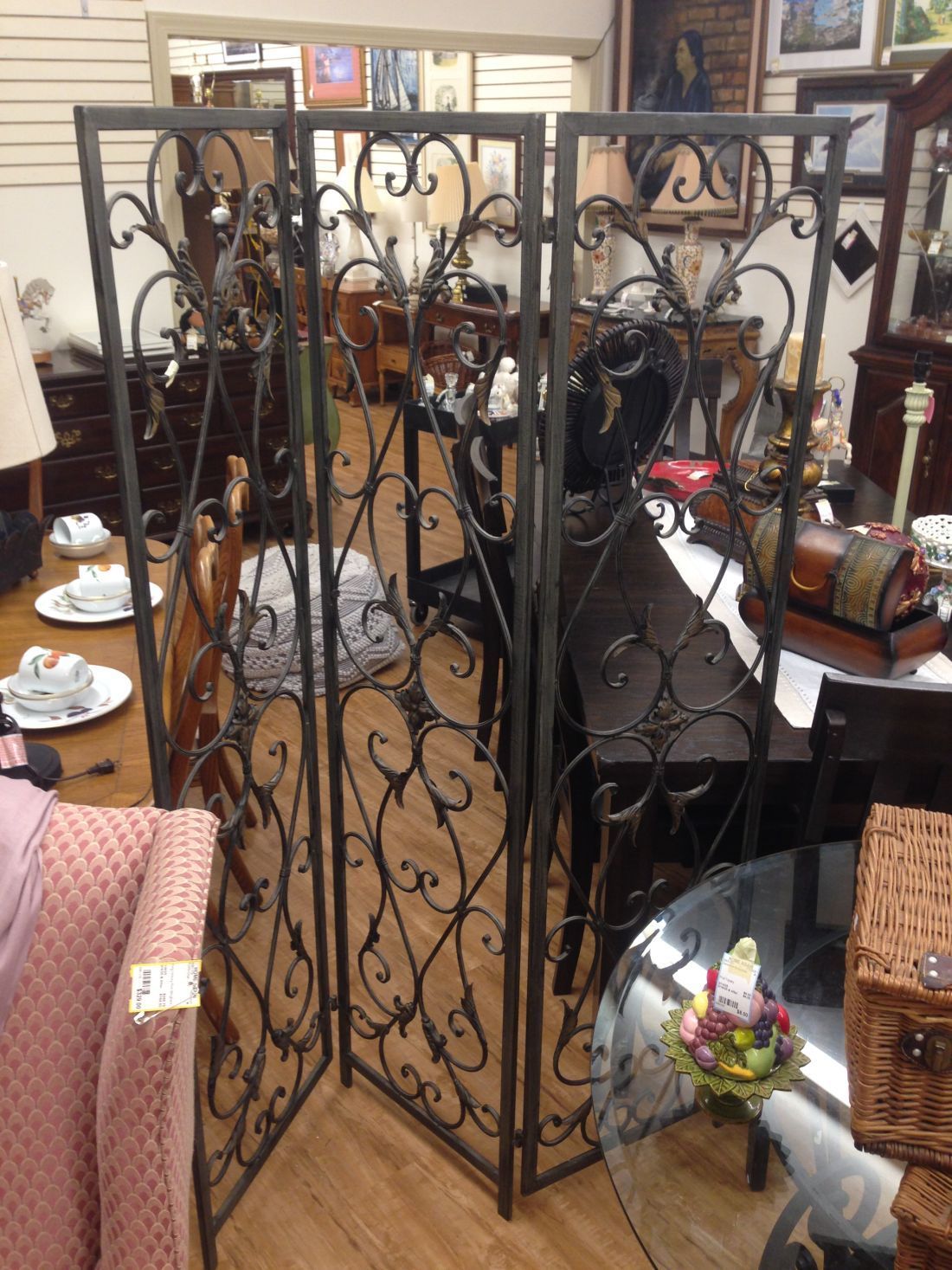 A wrought iron room divider in a living room