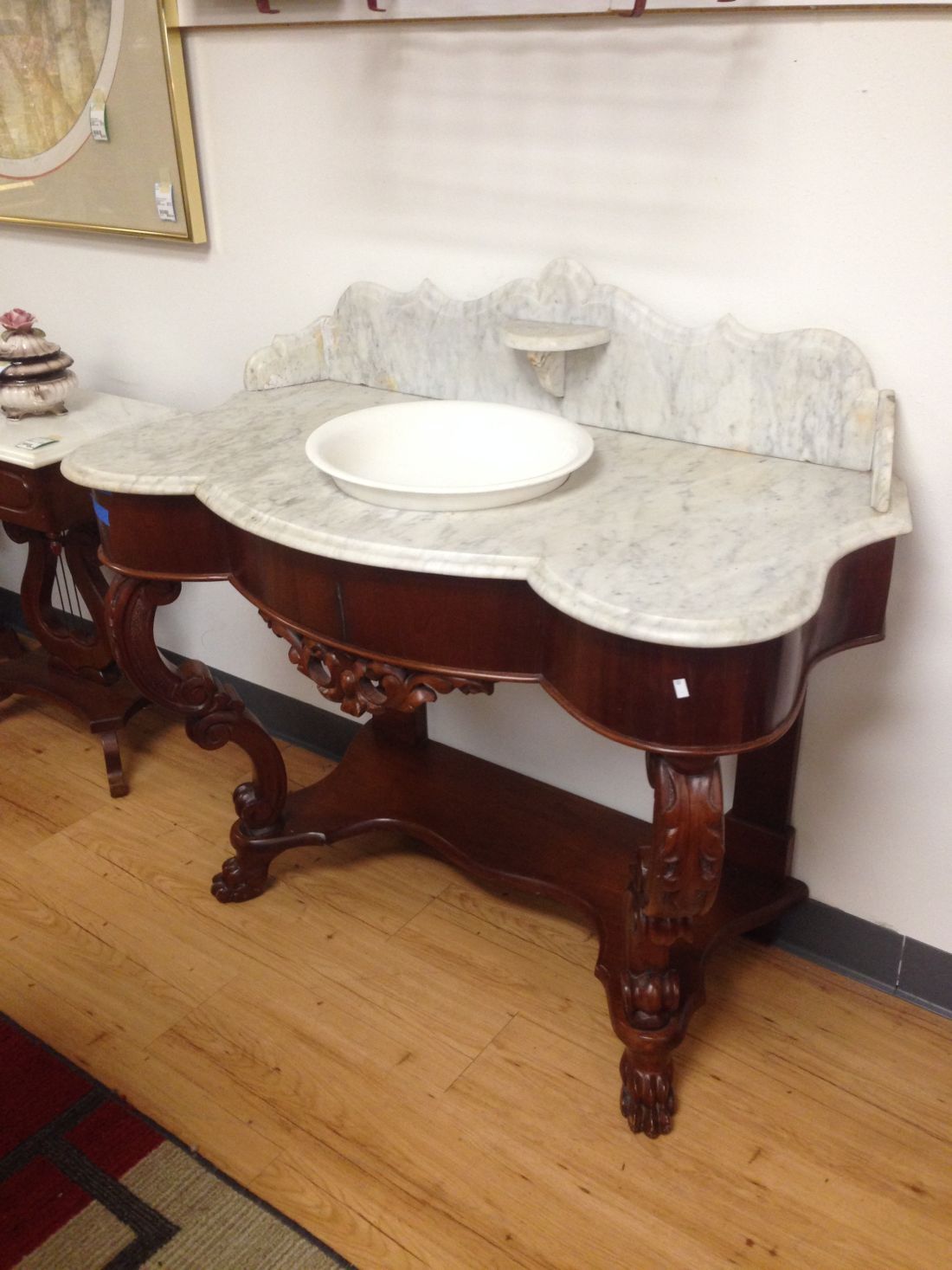 A wooden table with a marble top and a sink on it.