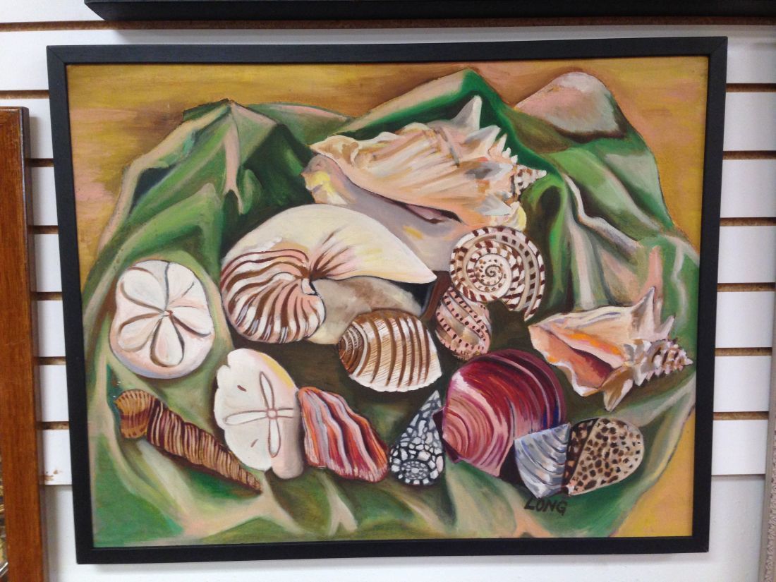 A painting of seashells and sand dollars on a green leaf