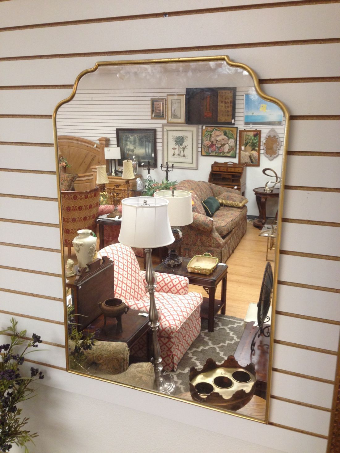 A living room is reflected in a large mirror.