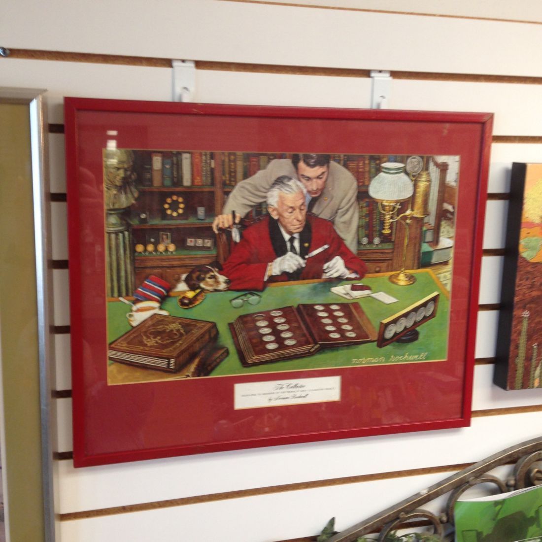 A framed picture of a man sitting at a desk