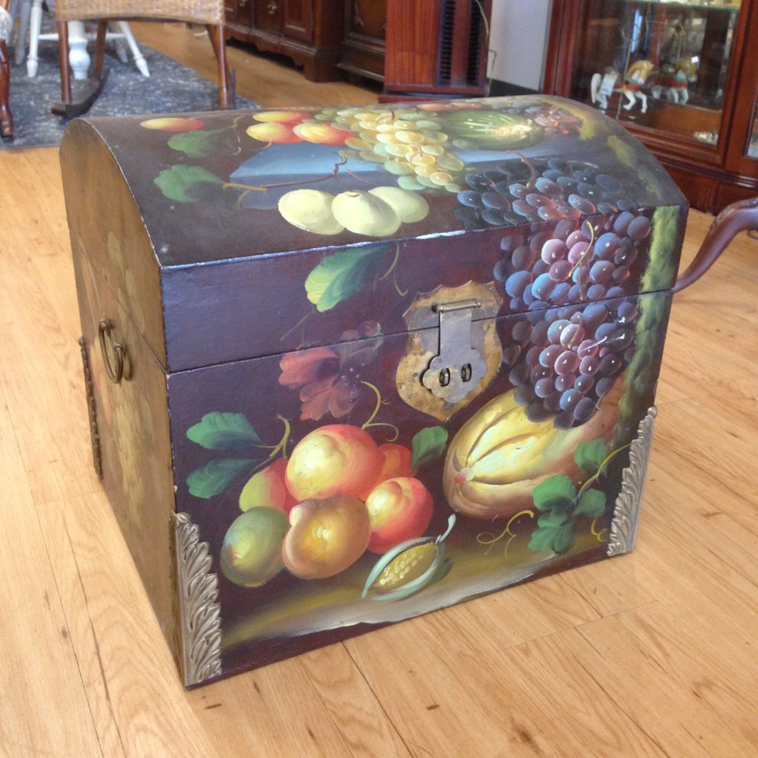 A trunk with a painting of fruit on it