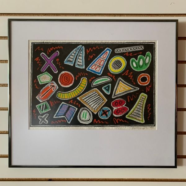A framed drawing of various shapes and letters