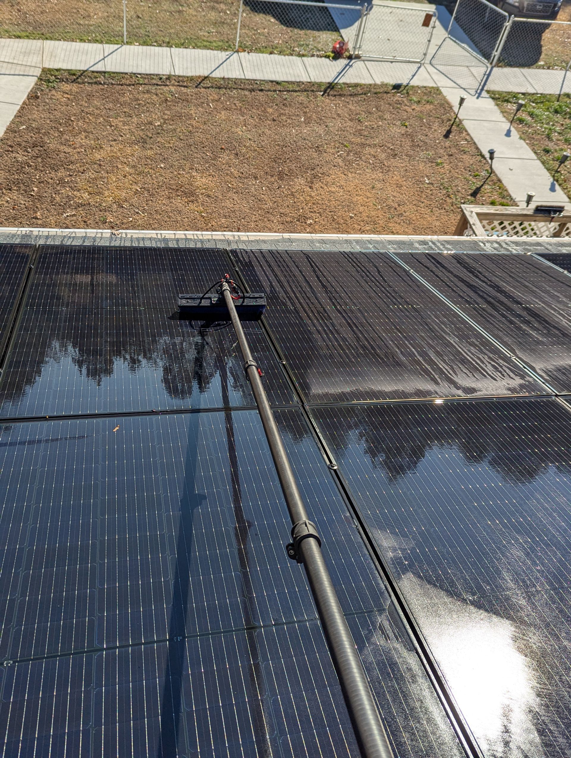 brushing solar panels to celan