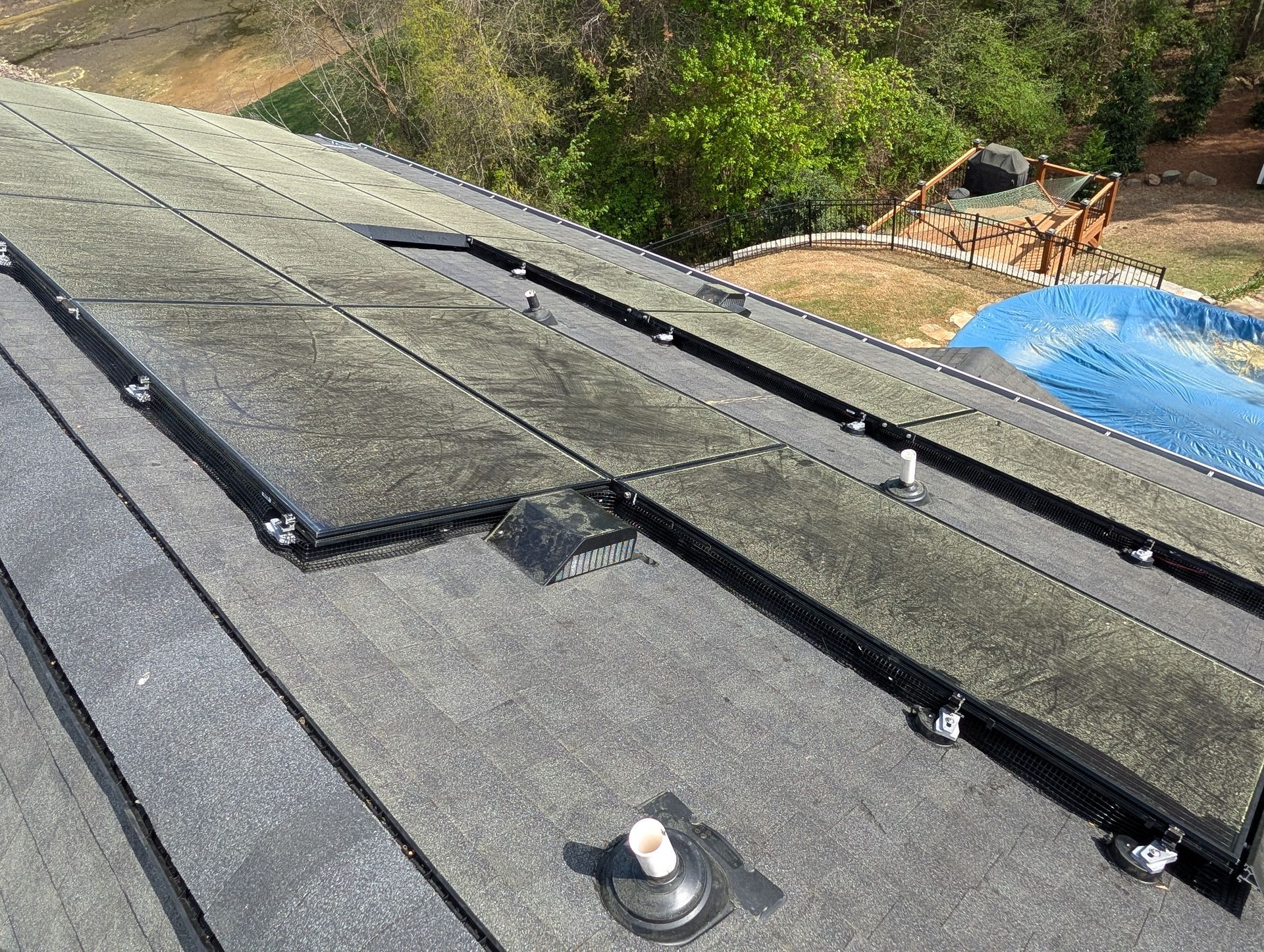 a roof-mounted array of dirty solar panels coated in yellow pollen