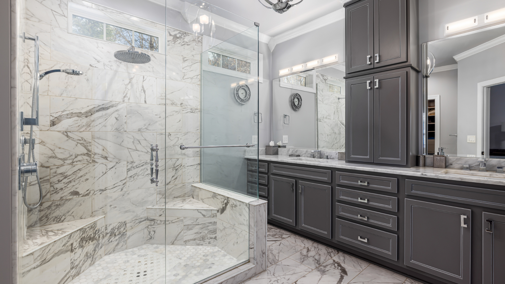 A bathroom with a walk in shower and two sinks.