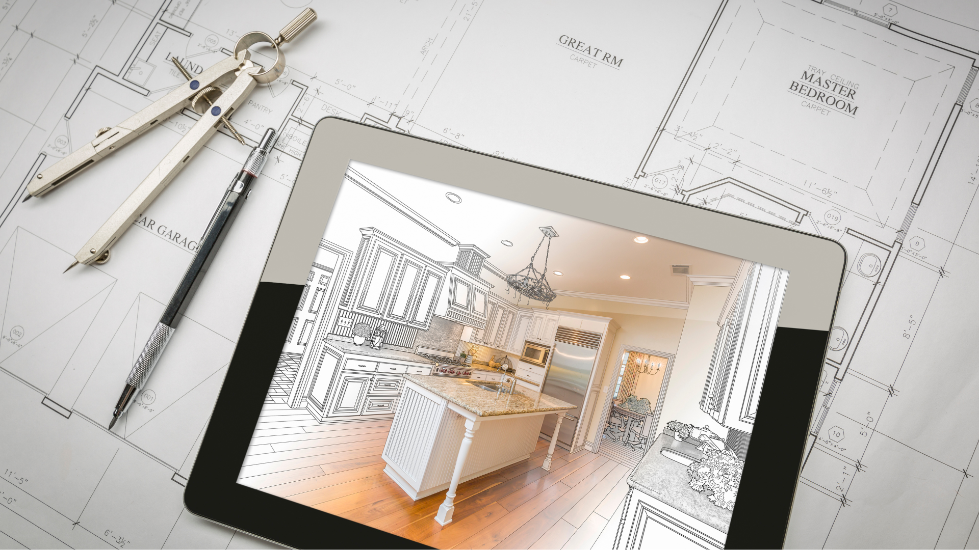 A tablet with a picture of a kitchen on it is sitting on top of a blueprint.