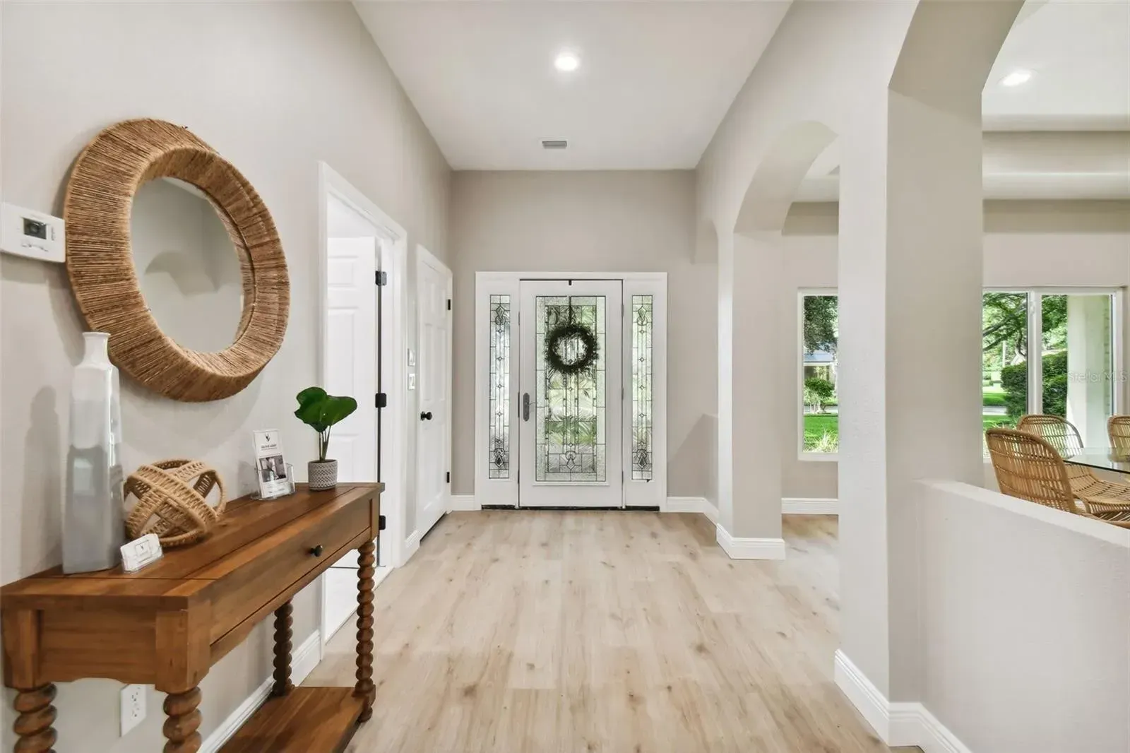 A living room with a couch , chair , table and rug.