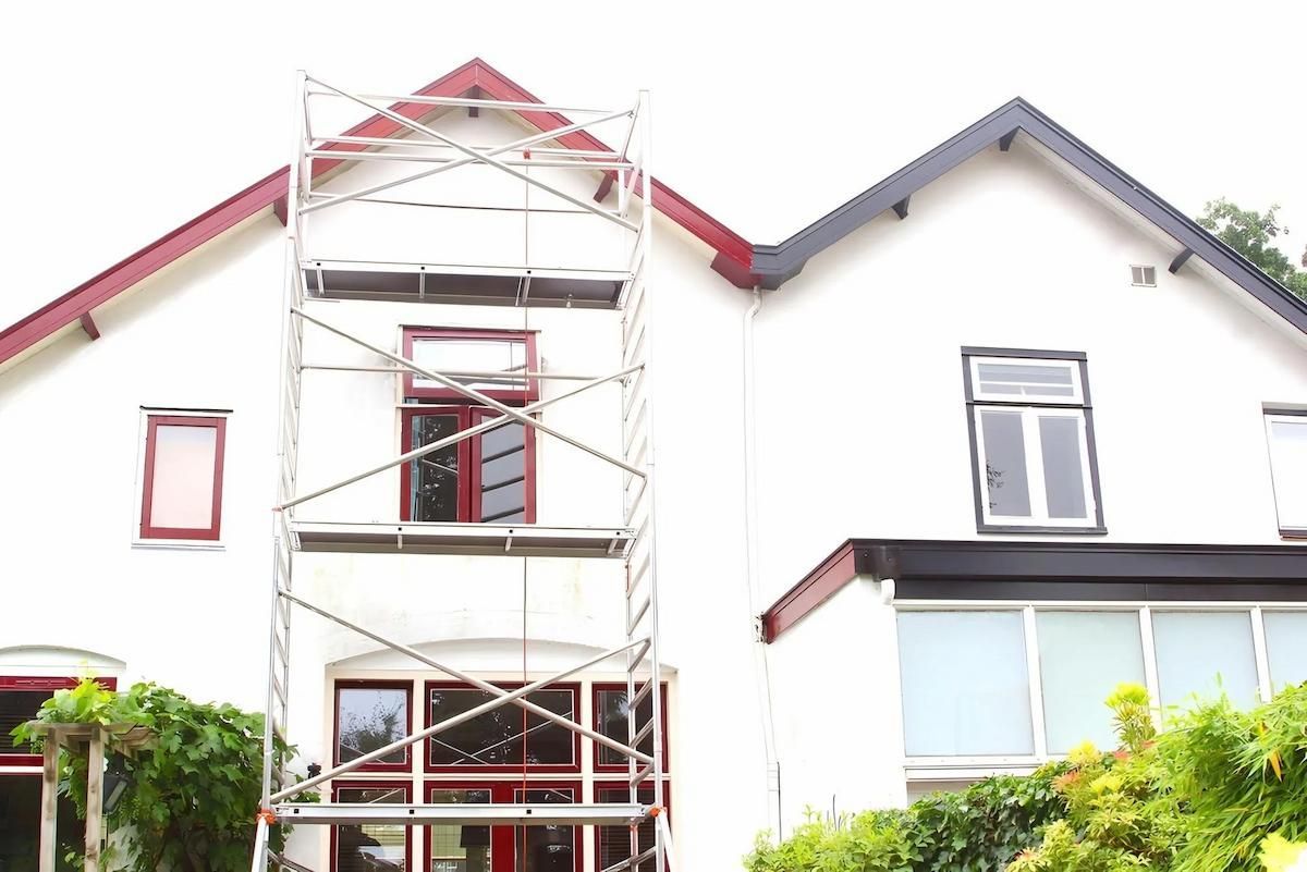 A White House With a Scaffolding in Front of It — O'Brien Painting Contractors in Noosa, QLD