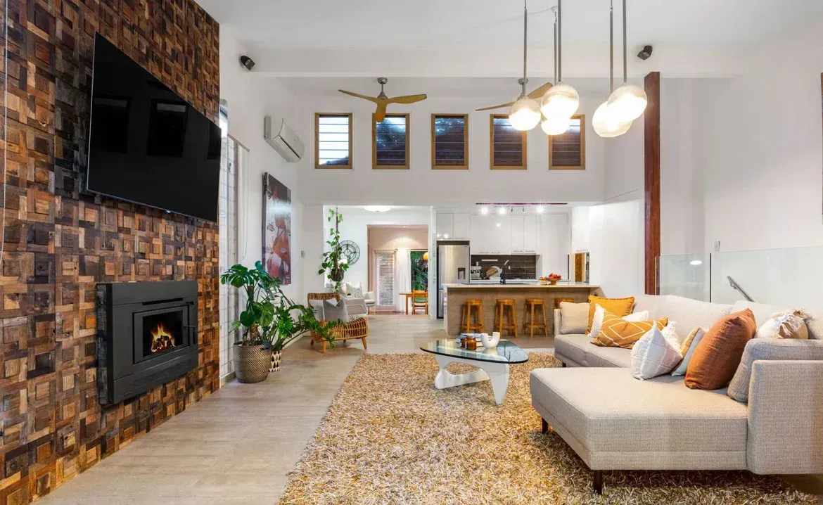 A Living Room With a Couch, Fireplace and Television — O'Brien Painting Contractors in Alexandra Headland, QLD